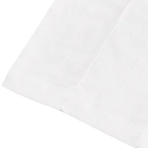 Close-up of white breathable linen fabric texture and hem stitching on men's beach trousers