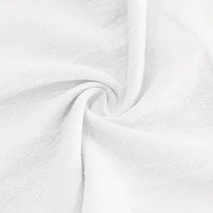 Detailed close-up of white breathable linen fabric texture for summer beach trousers