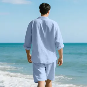 Detailed rear view of a man wearing a light blue linen two-piece set on a sunny beach