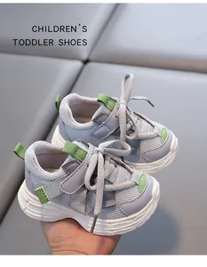 Close-up view of grey and green breathable mesh toddler sneakers with velcro strap details