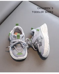 Close-up of breathable grey mesh children's toddler shoes with green accents