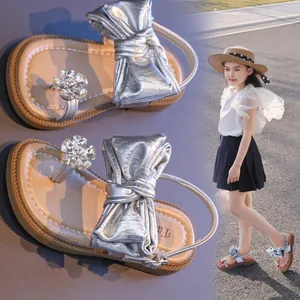 Elegant silver girls sandals featuring oversized bow and rhinestone flower accents