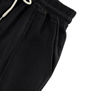 Close-up of elastic waistband and drawstring on black linen trousers