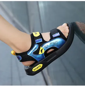 Close-up of boys' sport sandals with blue metallic accents and non-slip black sole.