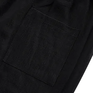 Close-up detail of a square back pocket on breathable black linen casual beach pants.