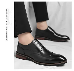 Detailed view of elegant black men's wingtip Oxford shoes with polished leather finish