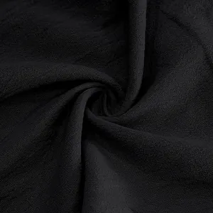 Close-up view showing the breathable black linen fabric texture of men's casual trousers.