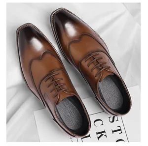 Top view of elegant brown burnished leather Oxford shoes for men on white background