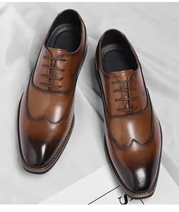Close-up top view of men's brown leather wingtip oxford shoes with burnished toe detail