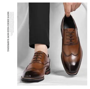 Detail showing the elegant brown leather and wingtip design of men's Oxford shoes.