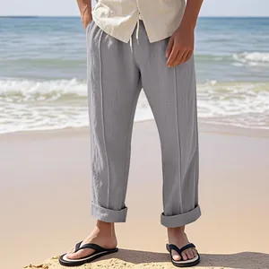 Men's loose gray linen pants shown in a casual beach setting for summer