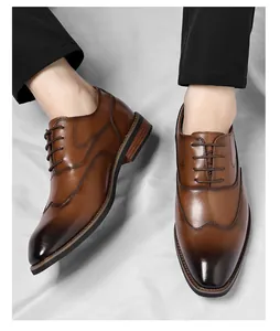 Top-down view of men's brown wingtip Oxford shoes with elegant gradient and stitching details.