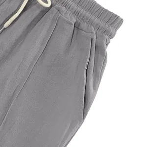 Close-up detail of the elastic waistband and side pocket on men's gray breathable linen trousers