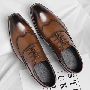 Classic men's brown leather oxford shoes with burnished toe and lace-up design