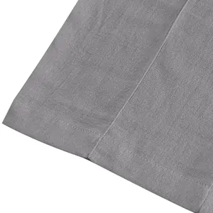 Macro view showing the breathable gray linen fabric texture and hem stitching detail.