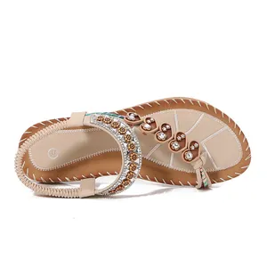 Bohemian style flat sandals for women with heart and floral rhinestone decorations.