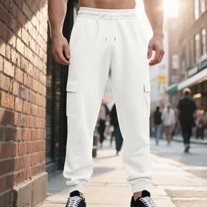 Detail view of white heavy textured cargo pants for men in casual urban street style