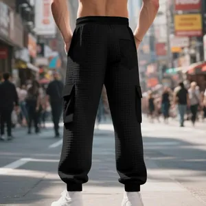 Detail view of men's heavy jacquard cargo joggers with elastic cuffs and back pocket