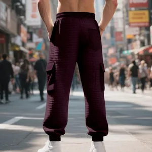 Detailed back view of men's burgundy jacquard cargo pants featuring a textured quilted pattern