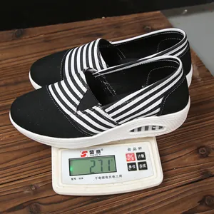 Detailed view of lightweight black striped canvas rocker shoe weighing 271g on scale