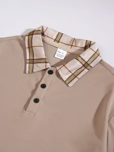 Close-up of men's beige waffle knit polo shirt featuring a plaid collar and black buttons.