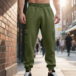 Detail view of men's olive green waffle knit cargo sweatpants with drawstring waist