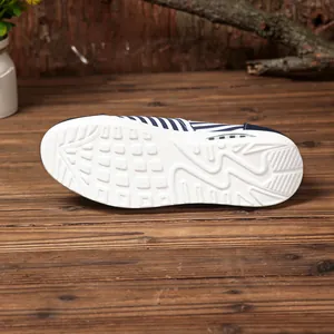 Close-up view showing the durable white anti-slip outsole of these striped canvas shoes