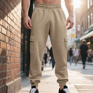 Detail view of men's heavy jacquard cargo joggers featuring premium textured waffle fabric