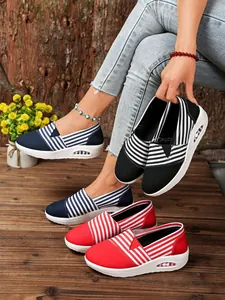 Detailed view of striped canvas rocking shoes in navy blue, black and red colors