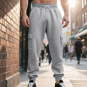 Detailed view of gray textured waffle knit cargo joggers for men with side cargo pockets