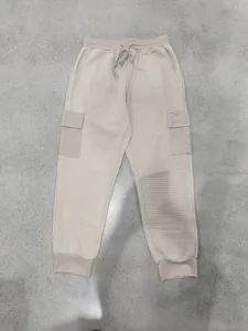 Full view of men's beige heavyweight waffle-knit cargo joggers with drawstring waist