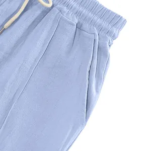 Detailed macro view of men's light blue breathable linen trousers with drawstring