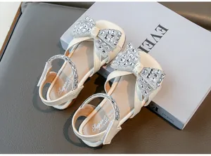 Vue détaillée de sandales de princesse pour filles avec un gros nœud en strass brillant