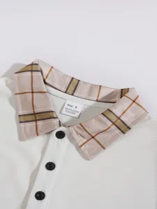 Detailed view of the plaid collar and waffle knit fabric on a men's white breathable polo shirt