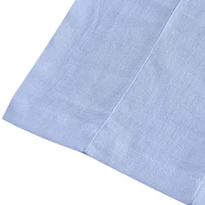 Close-up detail of breathable light blue linen fabric texture and stitching on men's pants