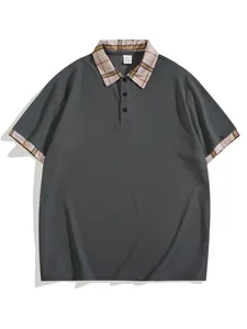 Close-up detail of a dark grey men's polo shirt featuring a plaid collar and button placket