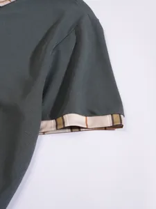 Detail shot of men's breathable polo shirt sleeve featuring a stylish striped cuff