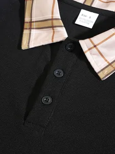 Detailed close-up view of men's black knit polo shirt featuring a stylish plaid collar
