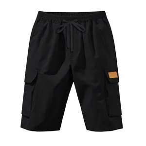 Detailed view of black men's tactical cargo shorts with multi-pockets and drawstring