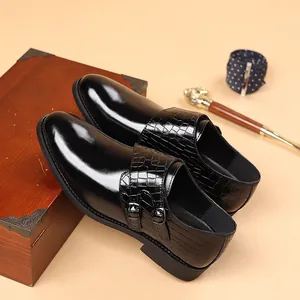 Close-up of black leather monk strap dress shoes with crocodile texture detail for men
