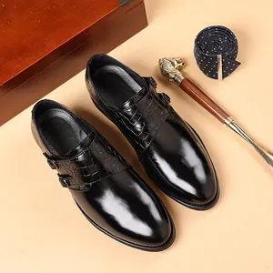 Detailed view of black double monk strap dress shoes with crocodile leather texture detail