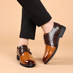 Close-up of men's brown formal leather shoes with crocodile-embossed texture and monk strap.