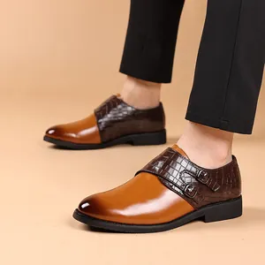 Close-up of men's brown monk strap leather shoes with crocodile texture detail