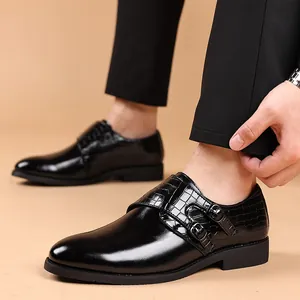 Close-up of black men's formal shoes with embossed crocodile texture and double buckles.
