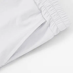 Close-up of white cargo shorts elastic waistband and side pocket detail