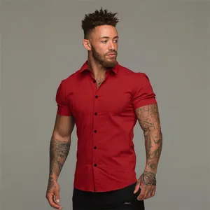 Front view of a muscular man wearing a slim fit red short sleeve casual button down shirt