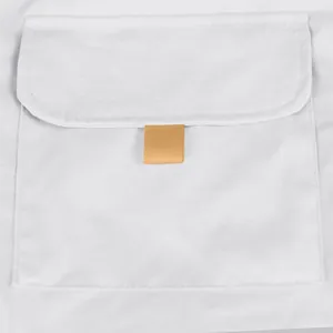 Close-up detail of cargo pocket flap on light grey tactical shorts with tan pull tab.