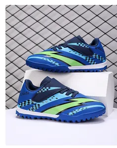 Side view of blue children's turf soccer shoes with neon green stripes and velcro strap