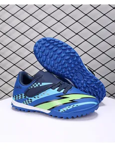 Detailed view of kids' blue soccer shoes with TF turf studs and velcro straps