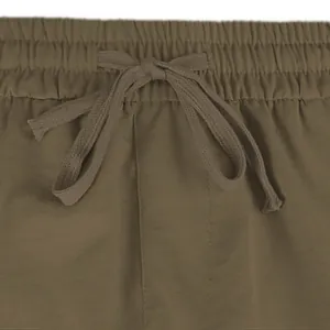 Close-up of olive green cargo shorts featuring elastic waistband and adjustable drawstring
